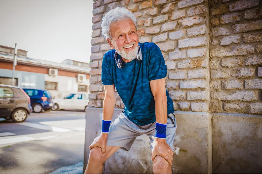 older man with hand on legs