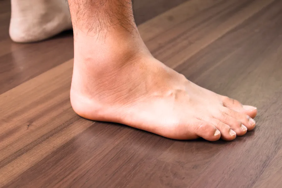 Closeup of a foot on wooden floor